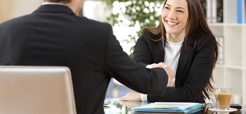 A businesswoman accepting her new job offer with a handshake