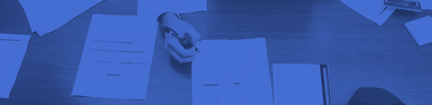 An overhead view of a woman signing forms