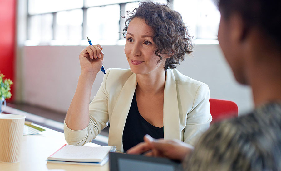 A confident woman in a meeting with her team